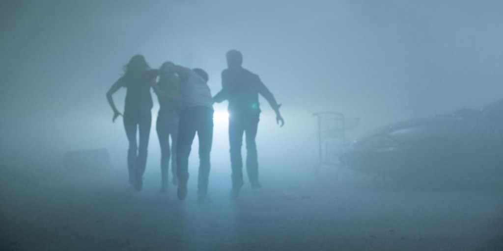 The survivors run through the mist.